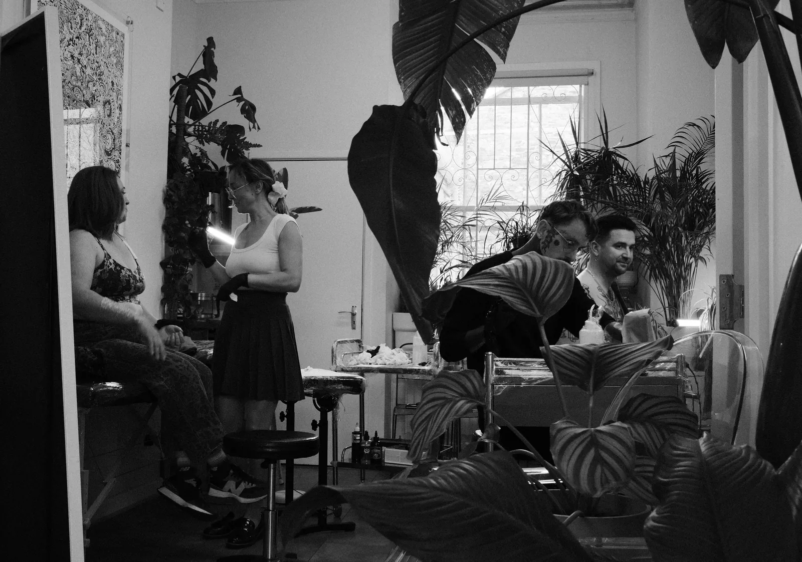 Gosia and Simon both tattooing clients at One Point Zero studio, Clifton, Bristol